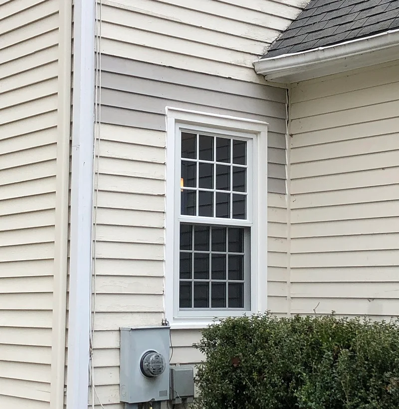 Damaged cedar siding repaired above this replacement window